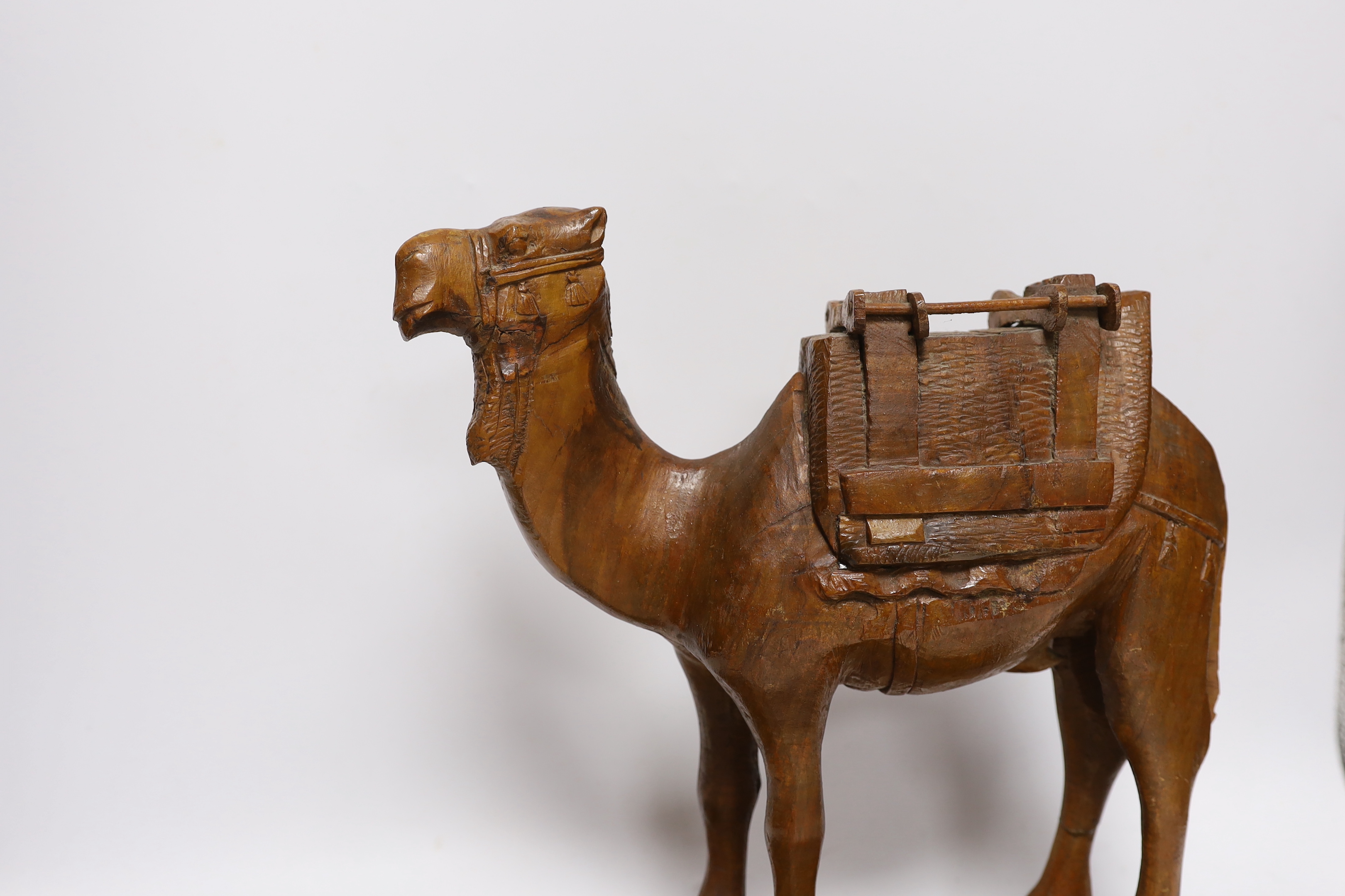 A Jerusalem carved olivewood camel pen / desk ink stand, 34cm wide